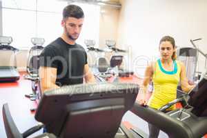 Couple using treadmills together