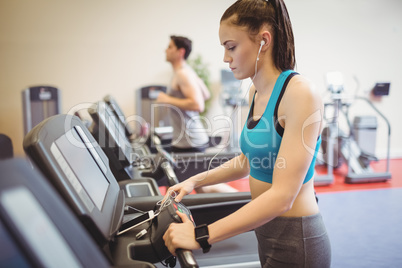 Fit woman using the treadmill