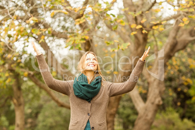 Smiling woman with arms raised