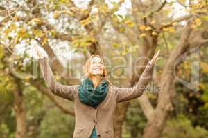 Smiling woman with arms raised