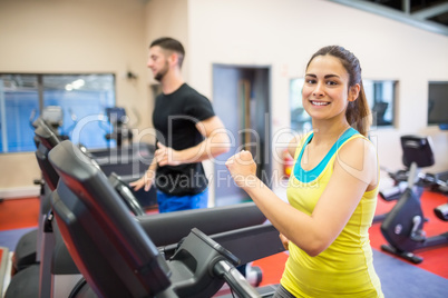 Man and woman using treadmills