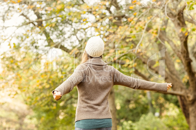 Rear view of a woman with arms outstretched