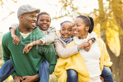 Portrait of a young smiling family in piggyback