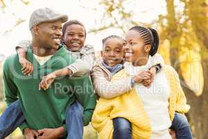 Portrait of a young smiling family in piggyback