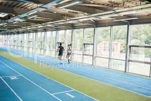 Couple running on the indoor track