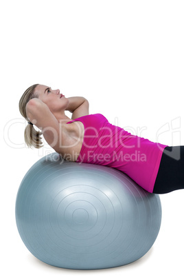 Muscular woman exercising on ball