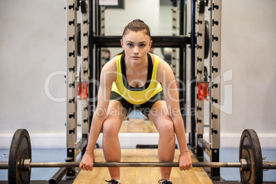 Woman lifting barbell and weights