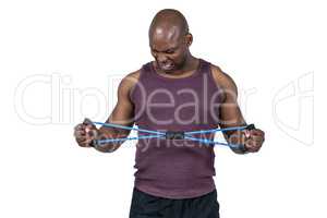 Fit man exercising with resistance band
