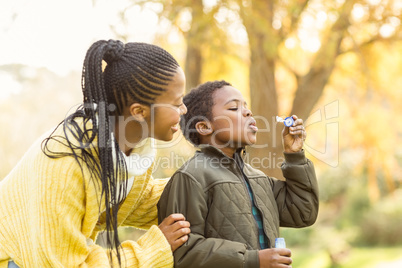 Little boy doing some bubbles with his mother