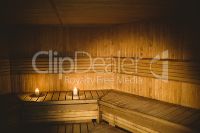 A sauna room with lit candles