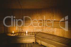 A sauna room with lit candles