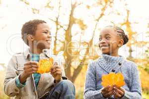 Portrait of young children holding leaves