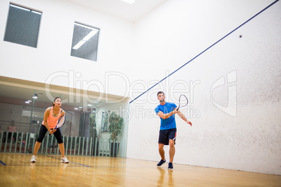 Couple playing a game of squash