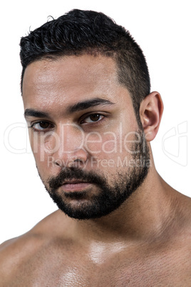 Muscular man frowning at camera