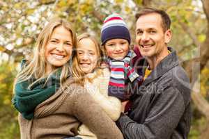 Smiling young family posing together