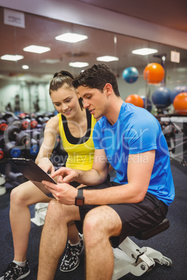 Trainer and client discussing her progress