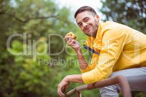 Fit man eating an apple
