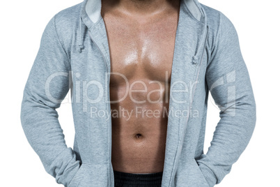 Muscular man in hooded jumper