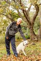 Senior man with his dog in park