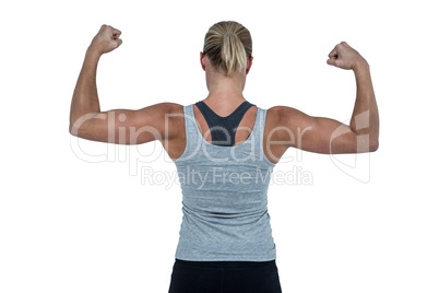 Rear view of muscular woman flexing muscles