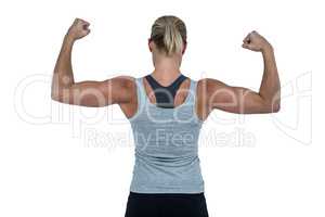 Rear view of muscular woman flexing muscles