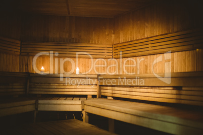 A sauna room with lit candles