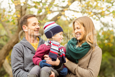 Smiling young couple with small boy posing