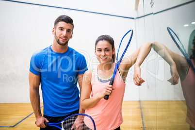 Happy couple about to play squash