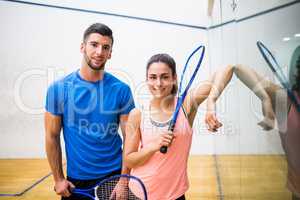 Happy couple about to play squash