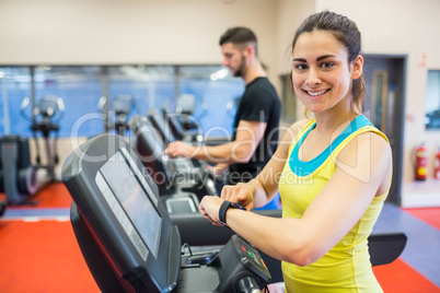 Couple using treadmills together