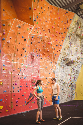 Fit couple at the rock climbing wall