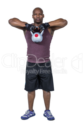 Fit man exercising with kettlebell