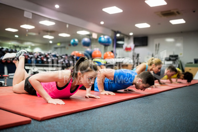 Fit people working out in fitness class