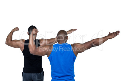 Strong friends posing with arms out