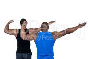 Strong friends posing with arms out