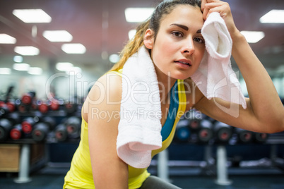 Woman drying her forehead from a workout