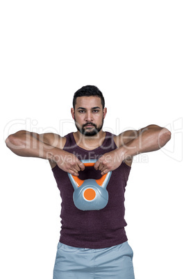 Muscular serious man lifting a kettlebell Muscular serious man lifting a kettlebell