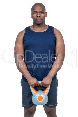 Muscular man exercising with kettlebell