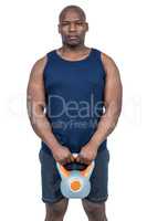 Muscular man exercising with kettlebell