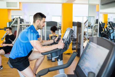 Fit man using the exercise bike