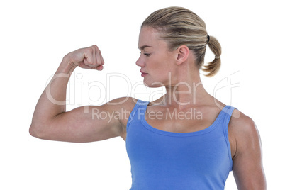 Muscular woman flexing her muscle