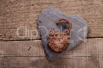 Rusty padlock on a heart shape