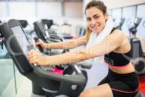 Smiling woman on the exercise bike