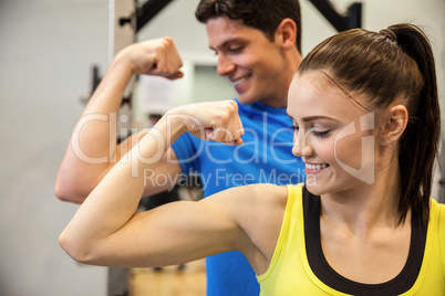 Happy couple showing off their biceps
