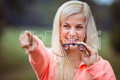 Happy blonde looking through binoculars