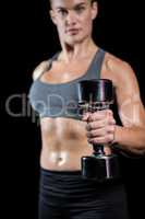 Muscular woman lifting heavy dumbbells