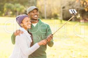 Young smiling couple taking selfies