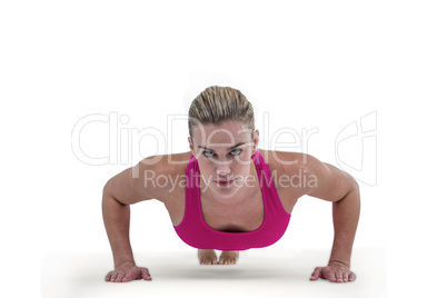 Portrait of pretty woman doing push ups