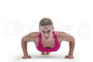 Portrait of pretty woman doing push ups