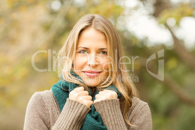Smiling woman holding her scarf